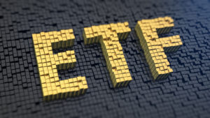 Acronym 'ETF' of the yellow square pixels on a black matrix background. Stocks fund concept.