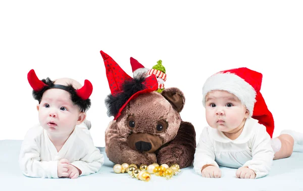 Две девочки ребенка Санта в Рождество на изолированных белом фоне понятие детства и праздник Лицензионные Стоковые Изображения